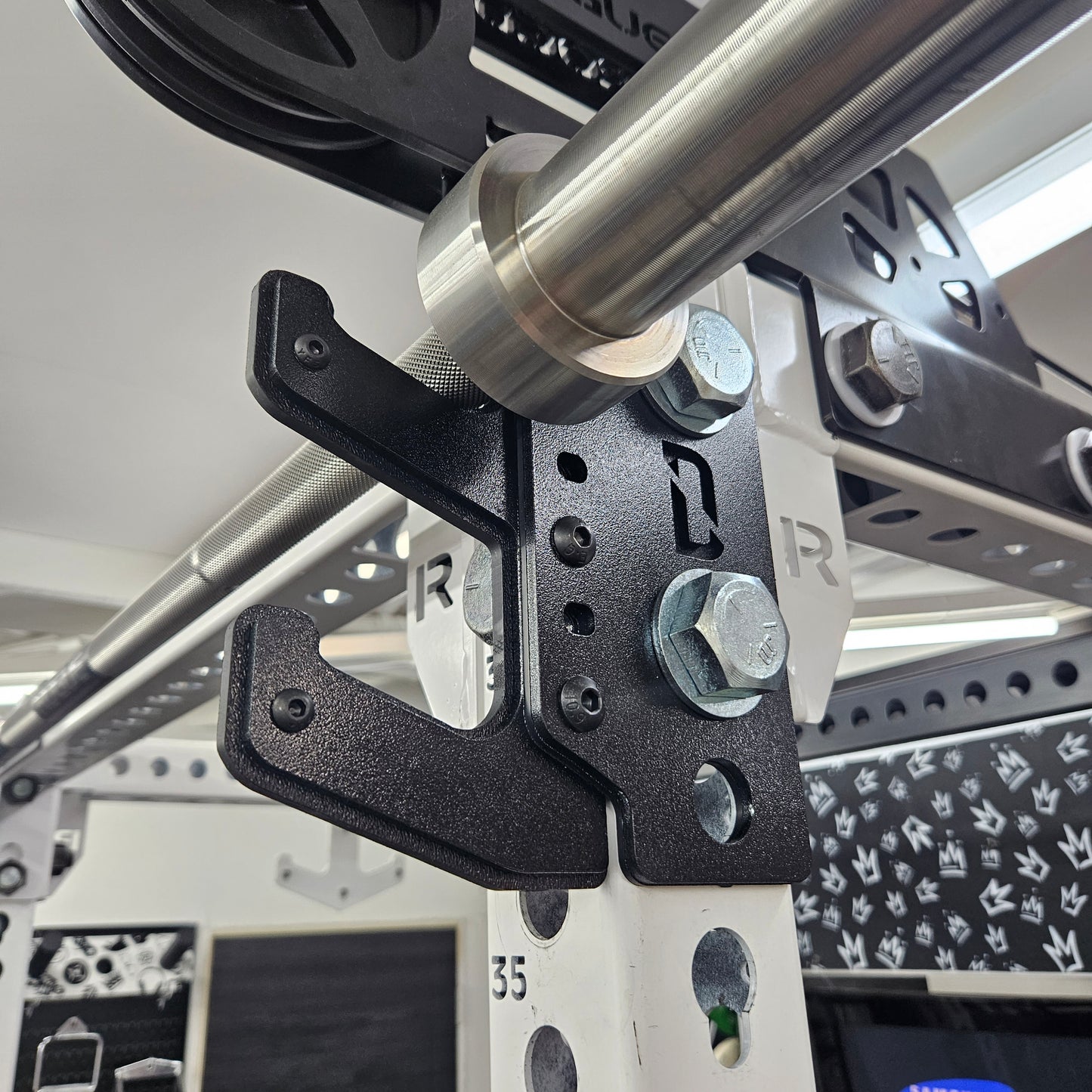Profile view of The Dock mounted holding a barbell across front of rack