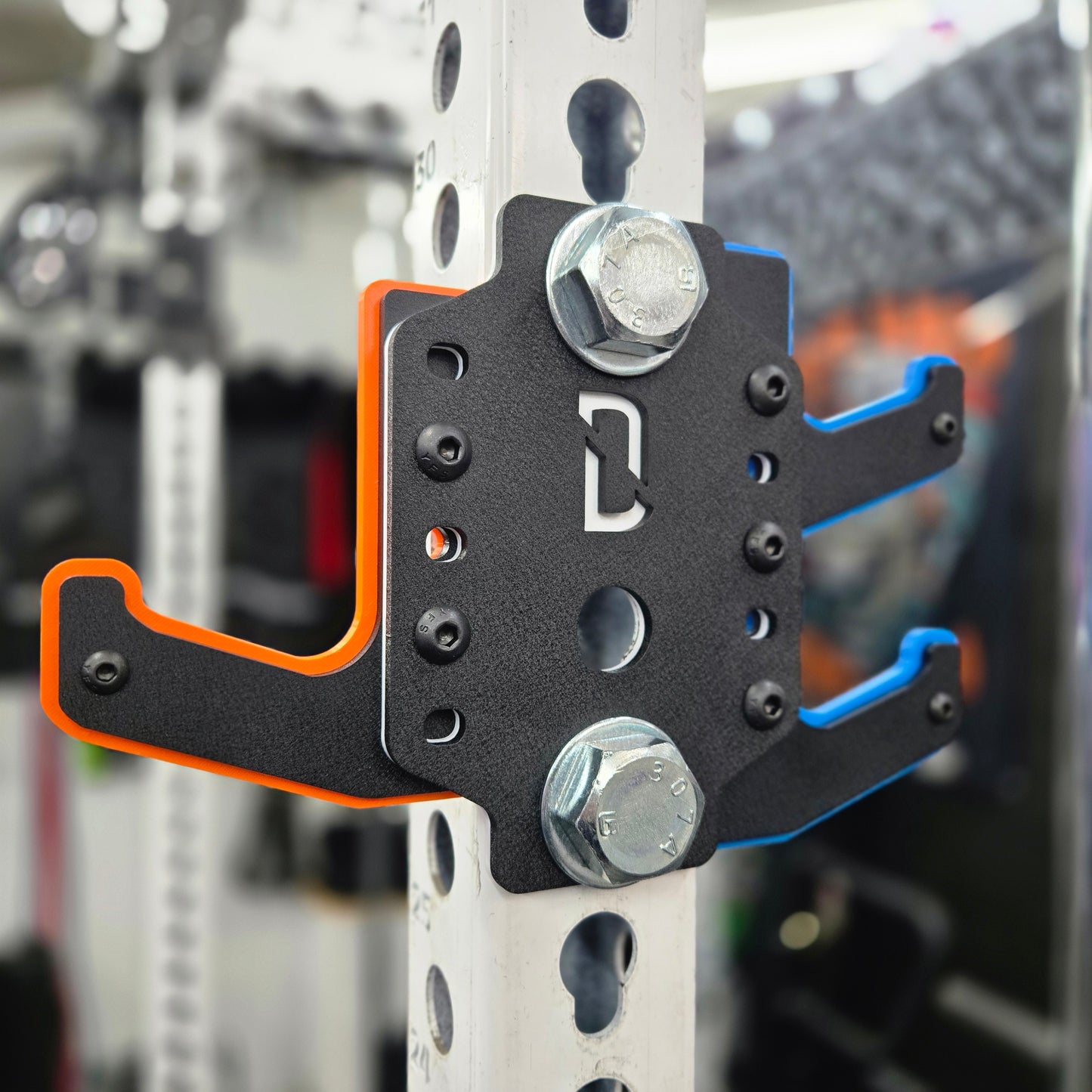 A black steel barbell storage rack accessory known as the DualDock, mounted on a vertical bar with visible orange and blue accents.