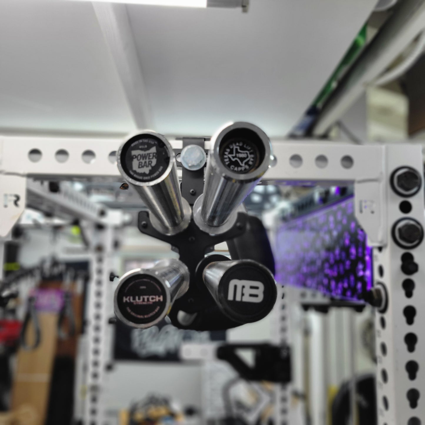 Double Decker Barbell Anchor mounted on a 5/8-inch power rack, holding two barbells vertically